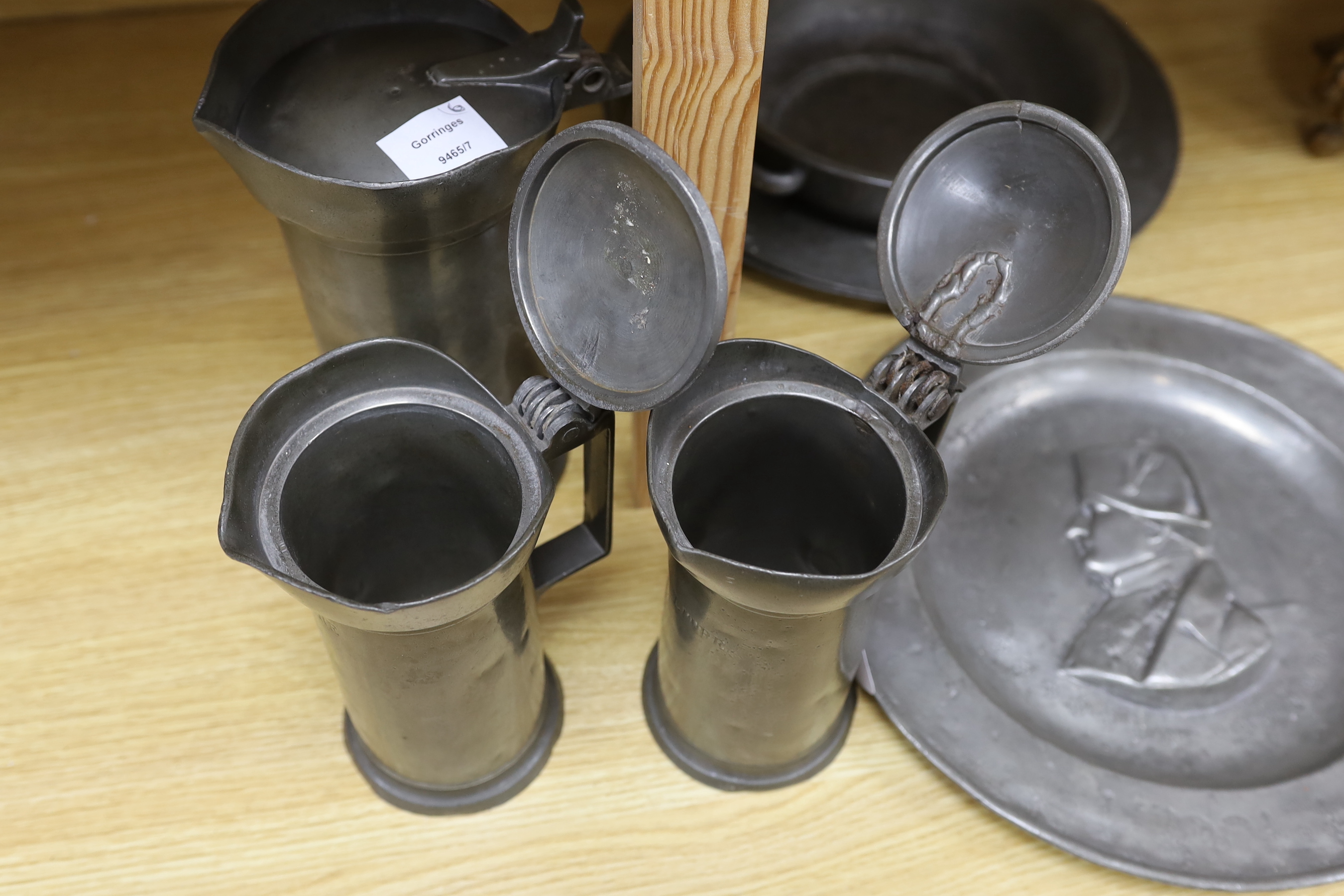 Three 18th century French pewter flagons and chargers, largest 39cm diameter